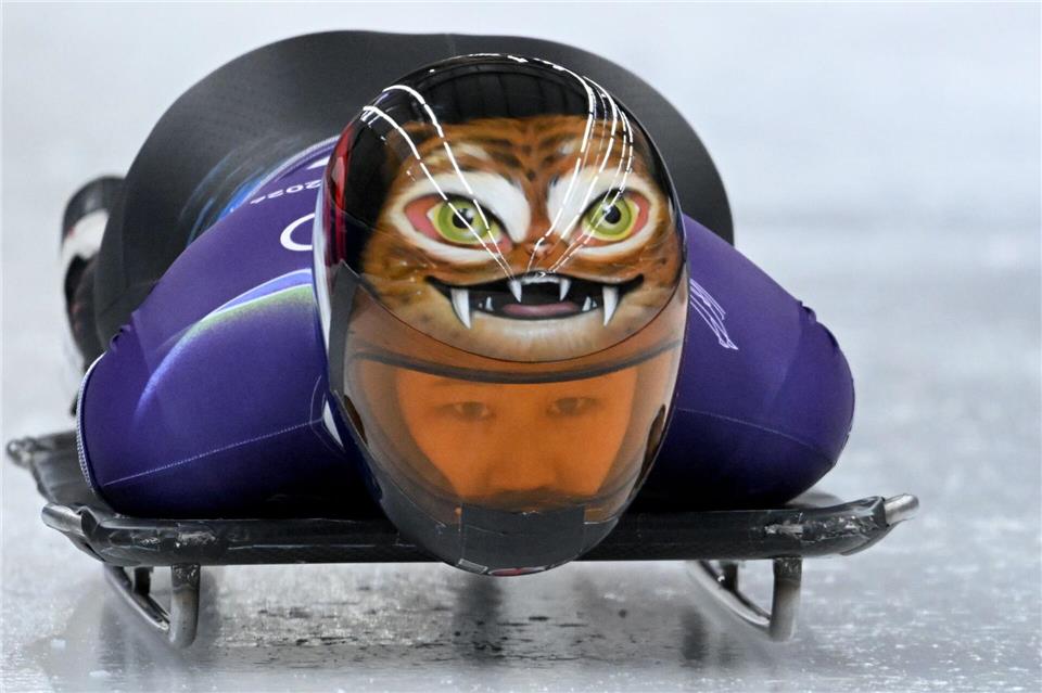  Helm mit Biss: Bei den Olympischen Winterspielen trägt die nordkoreanische Skeleton-Pilotin Hong Sujung im Training einen ausgefallenen Kopfschutz.Robert Michael/dpa