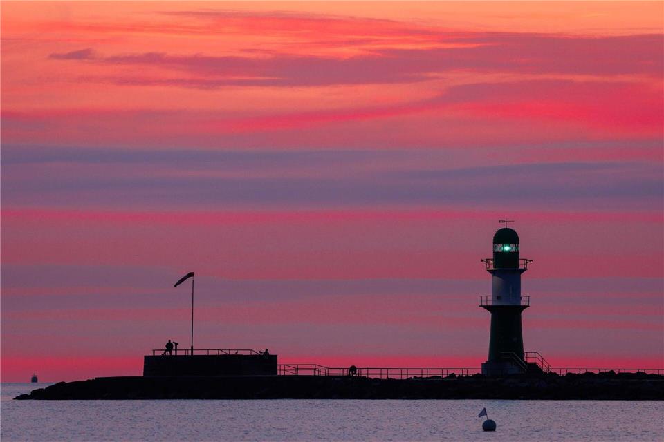  Leuchtfeuer auf der Mole in Warnemünde blinkt vor SonnenaufgangJens Büttner/dpa