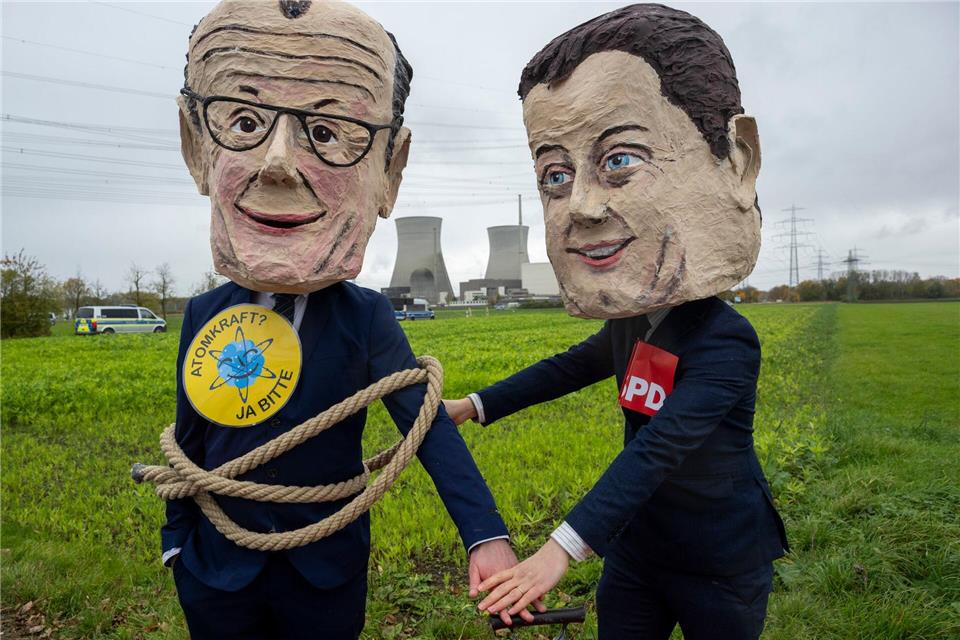 Als Bundeskanzler Friedrich Merz (l) und SPD-Vorsitzender Lars Klingbeil verkleidete Atomkraftbefürworter demonstrieren gegen die Sprengung.Stefan Puchner/dpa