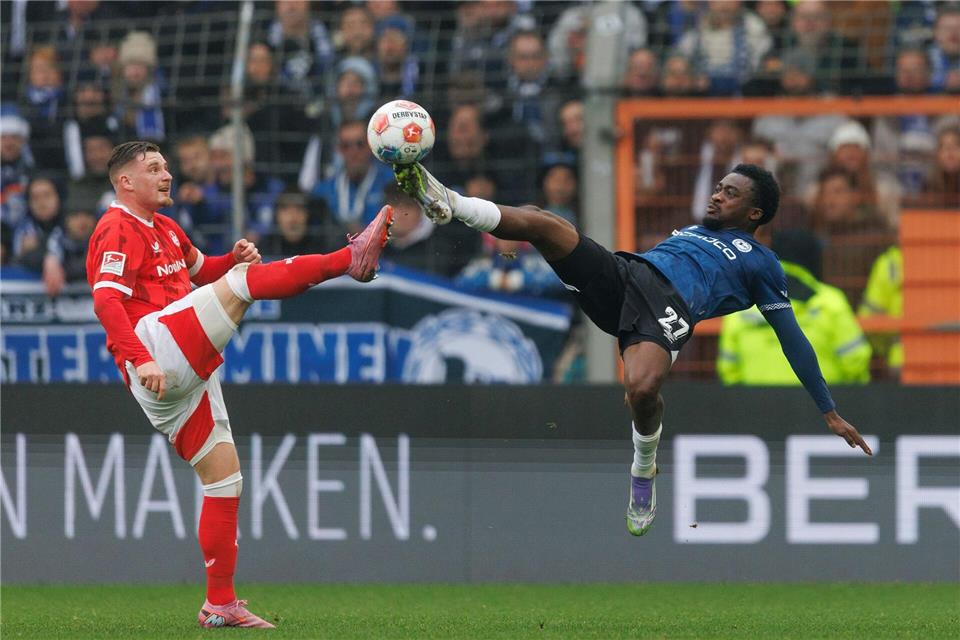 Artistische Einlage: Bielefelds Benjamin Boakye (r) ist einen Tick früher am Ball als FCK-Kapitän Marlon Ritter.Friso Gentsch/dpa
