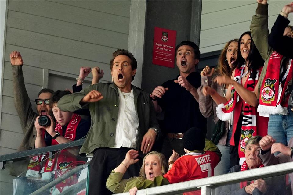 Auf der Tribüne bejubelte Miteigentümer Reynolds (Mitte l) den nächsten Aufstieg von Wrexham.Martin Rickett/PA Wire/dpa