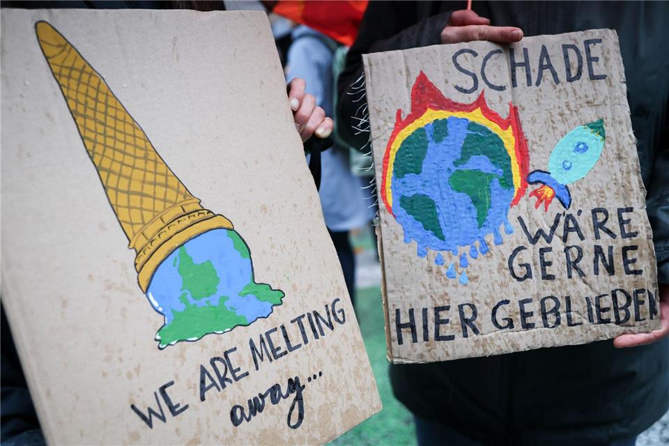 Auf einem Klimaprotest machen Plakate auf die eskalierende Krise aufmerksam. (Symbolbild)Christian Charisius/dpa