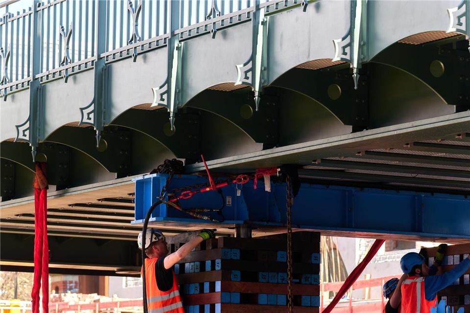 Bauarbeiter bringen ein Teil der neuen Eisenbahnüberführung an der Hamburger Schanzenstraße in Position. (Archivbild)Marcus Golejewski/dpa