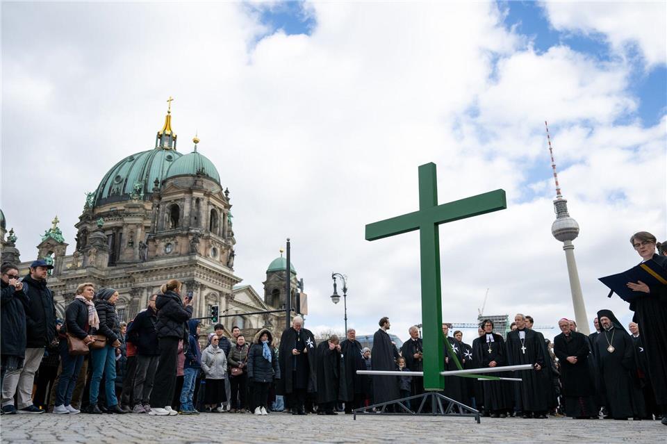 Bei der Karfreitagsprozession wurde auch dieses Jahr wieder ein goßes grünes Kreuz durch die Innenstadt getragen.Christophe Gateau/dpa