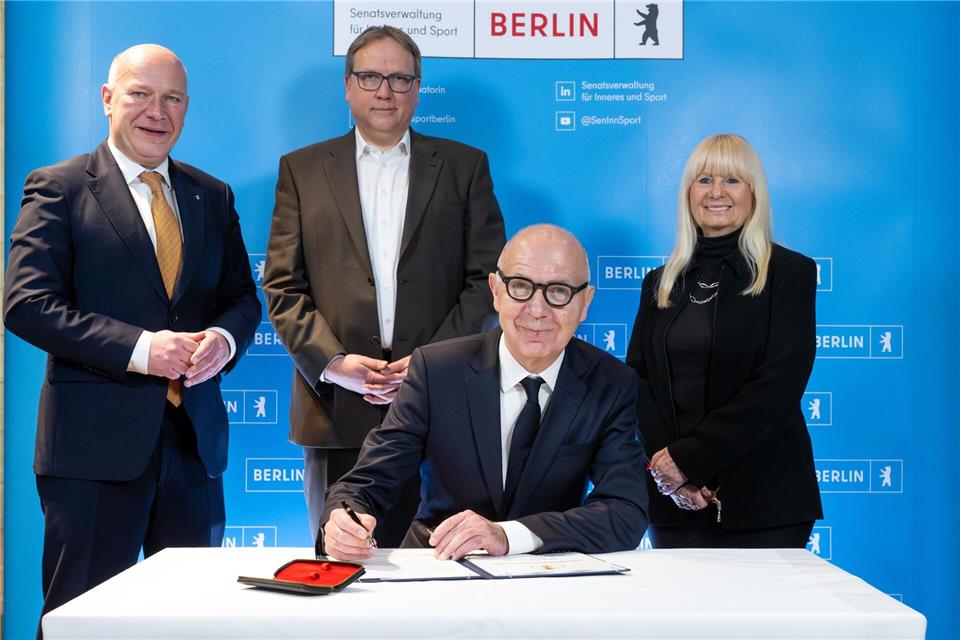 Bernd Neuendorf (vorne) bei der Unterzeichnung der Vereinbarung zum DFB-Pokal. Soeren Stache/dpa