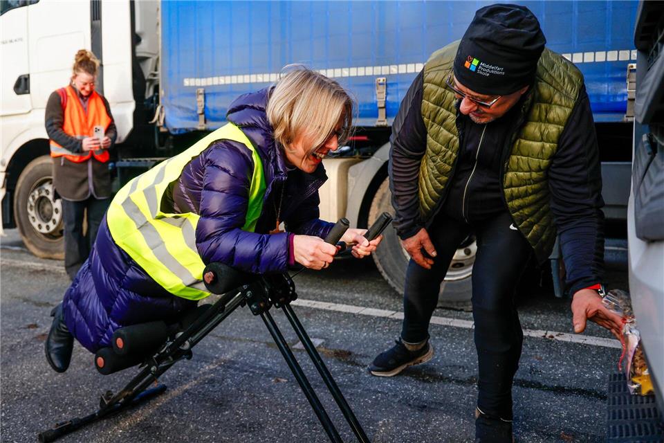 Bischöfin Steen testet bei der Weihnachtskation auf dem Rastplatz „Hüttener Berge Ost“ ein Fitness-Gerät aus.Frank Molter/dpa