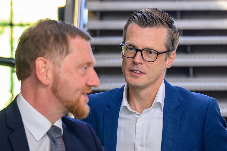 Danny Auerswald (rechts), Sprecher der Geschäftsführung von Volkswagen Sachsen, wird von Ministerpräsident Michael Kretschmer (CDU) zur Kabinettssitzung empfangen. Hendrik Schmidt/dpa