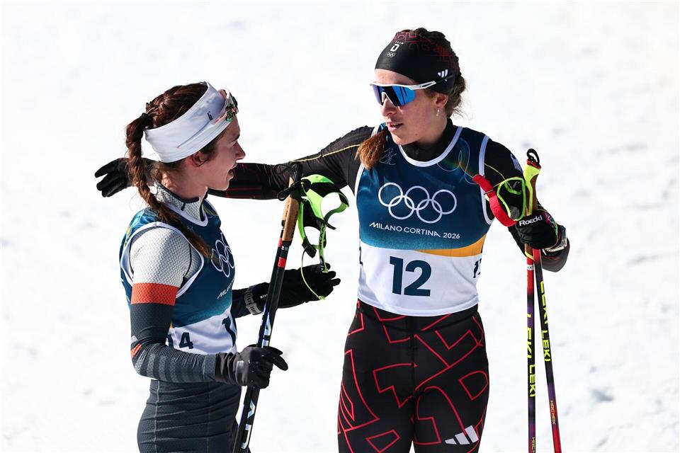 Darija Neprjajeva (l) nahm während des Olympia-Rennens versehentlich die Ski von Katharina Hennig Dotzler.Daniel Karmann/dpa