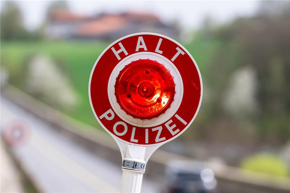 Der Polizist versuchte unter anderem mit einer Leuchtkelle, den Wagen anzuhalten. (Symbolbild)Armin Weigel/dpa