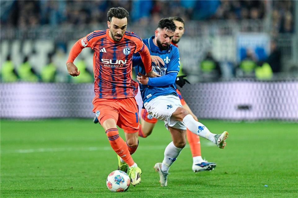 Der SV Darmstadt 98 um Marco Richter (r) und der FC Schalke 04 um Kenan Karaman schenkten sich nichts.Uwe Anspach/dpa