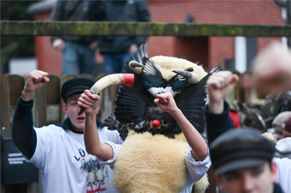 Die Klaasohms tragen traditionell Masken, Schafsfelle und Vogelfedern und haben ein Kuhhorn. Lars Penning/dpa