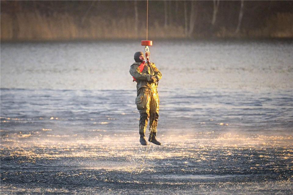 Die Marinetaucher üben die Bergung aus dem Wasser – dabei ist ein Helikopter im Einsatz. Sina Schuldt/dpa