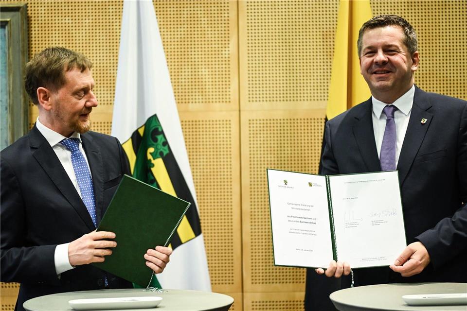 Die Regierungschefs von Sachsen und Sachsen-Anhalt unterzeichnen eine Erklärung für die Flughäfen. Britta Pedersen/dpa