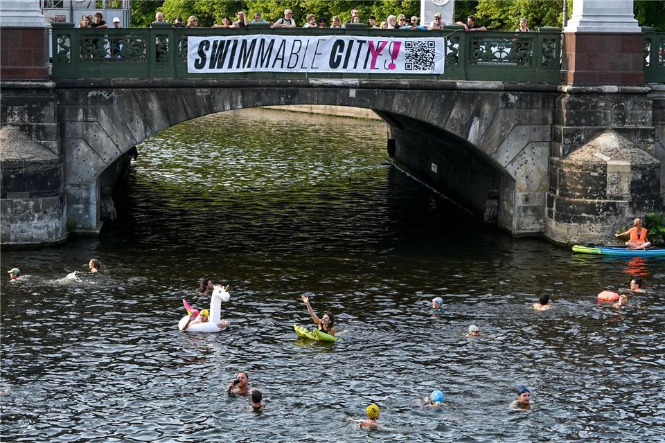Die Schwimmenden demonstrierten gegen das Badeverbot in dem Fluss.Jens Kalaene/dpa