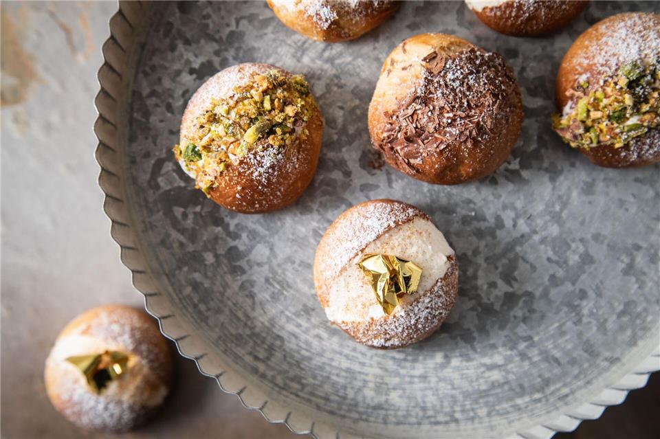 Diese fluffigen Milchbrötchen mit Cremefüllung werden Maritozzo Romano genannt. Sterneküchenmäßig werden sie mit Blattgold, Schokolade und Pistazien dekoriert. Christin Klose/dpa-tmn