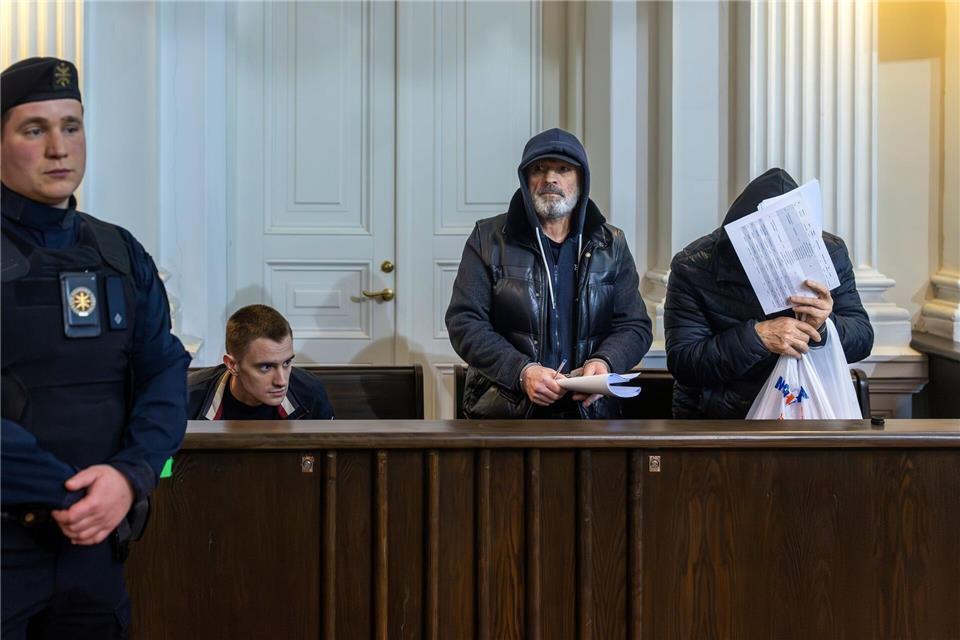 Drei der fünf Verdächtigen sitzen im Bezirksgericht auf der Anklagebank während ihrer ersten Anhörung. (Archivbild)Mindaugas Kulbis/AP/dpa