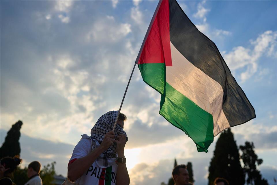 Ein Demonstrant schwenkt eine palästinensische Flagge während einer Demonstration vor dem griechischen Parlament. (Archivbild)Petros Giannakouris/AP/dpa