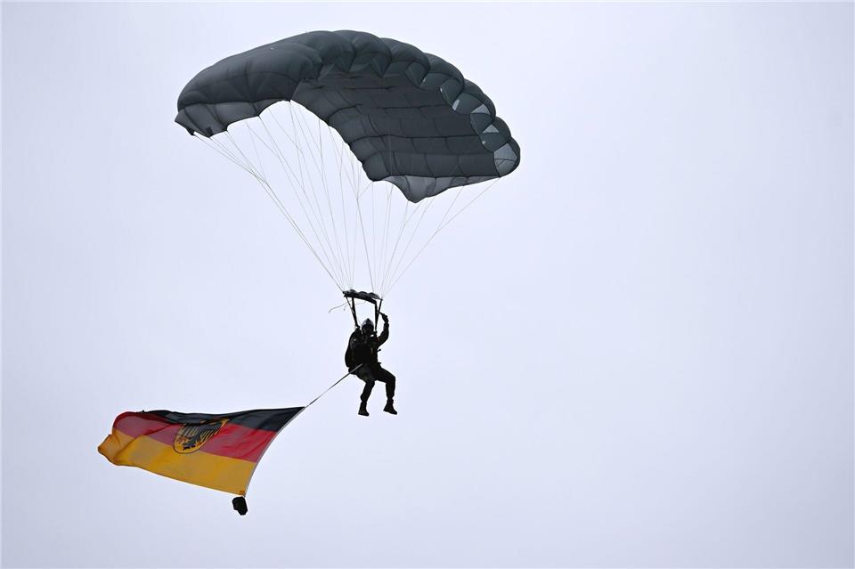 Ein Fallschirmspringer landete beim Tag der Bundeswehr auf dem Gelände der Münchner Bundeswehr-Uni.Sven Hoppe/dpa