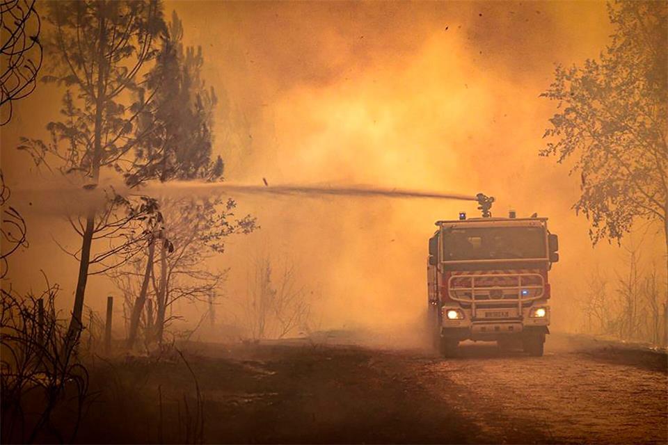 Ein Feuerwehrwagen sprüht Flüssigkeit auf einen Waldbrand in der Region Bordeaux. (Archivbild)Uncredited/Service Communication-Protocole SDIS 33/AP/dpa