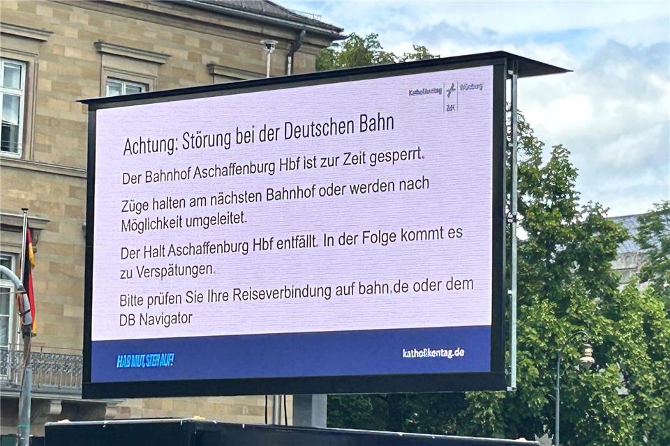 Ein Hinweis macht die Besucher des Katholikentags in Würzburg auf die wenig später aufgehobene Sperrung des Bahnhofs in Aschaffenburg aufmerksam. Angelika Resenhoeft/dpa