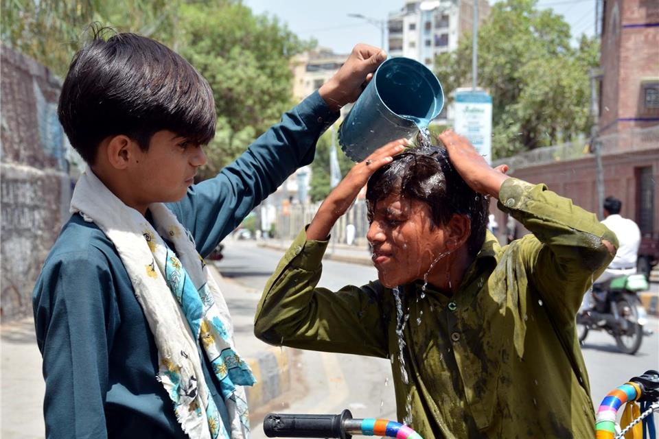 Hitzewarnung in Pakistan: Temperaturen über 50 Grad Ein Junge wäscht sich in Pakistan den Kopf, um sich an einem heißen Sommertag abzukühlen.
