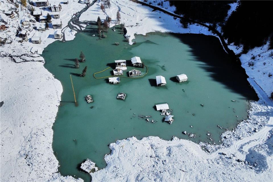 Bilder des Tages  Ein Luftbild zeigt das teilweise überflutete Dorf Blatten nach den jüngsten Schneefällen.Michael Probst/AP/dpa
