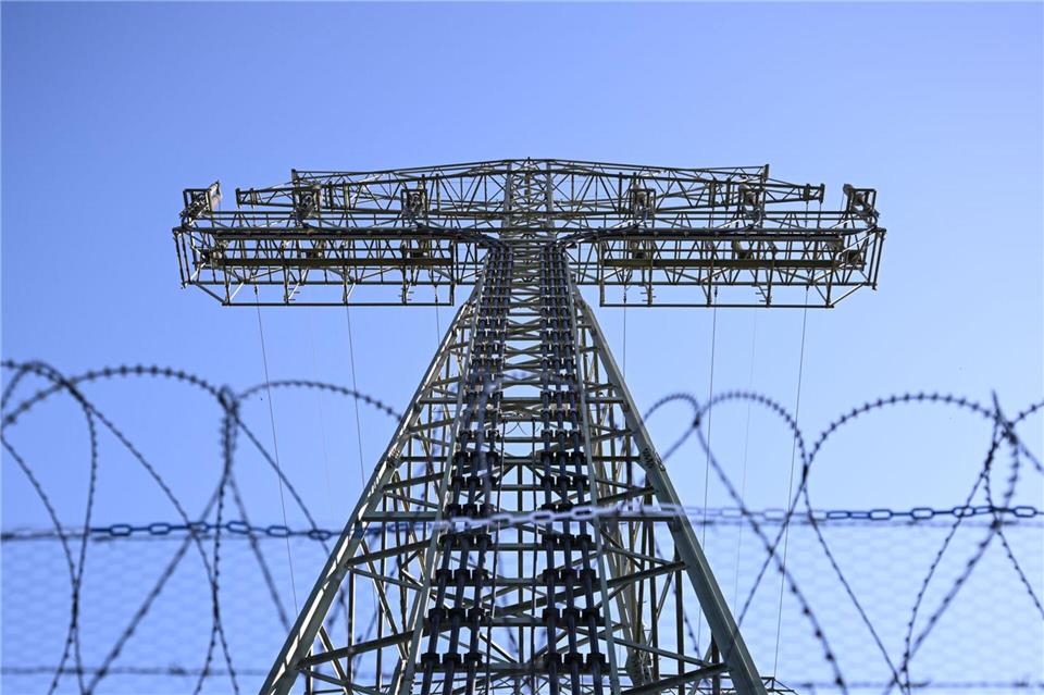 Ein verstärkter Zaun umgibt inzwischen den Strommast, der im September 2025 Ziel eines Brandanschlags wurde.Britta Pedersen/dpa