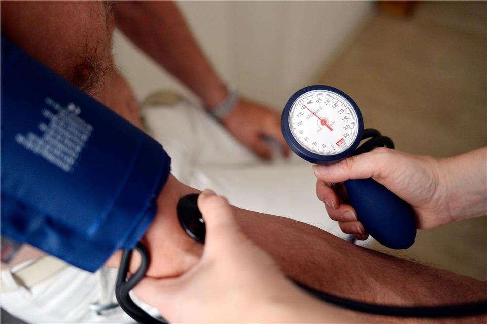 Eine Medizinerin misst den Blutdruck eines Patienten. (Symbolbild)picture alliance / dpa