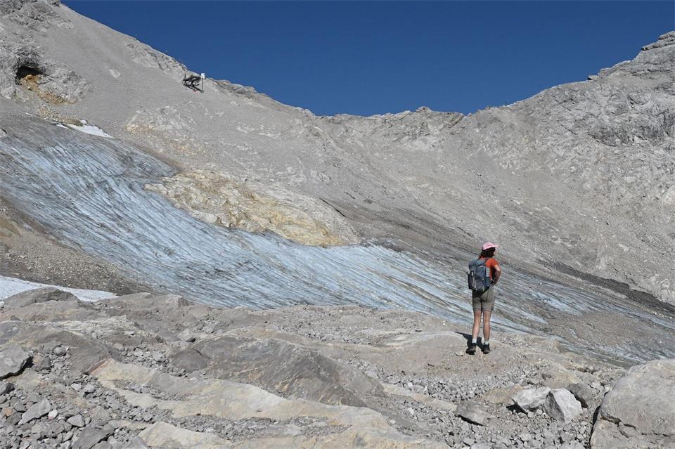 Eine Wandererin vor dem Nördlichen Schneeferner Gletscher unterhalb der Zugspitze.Angelika Warmuth/dpa