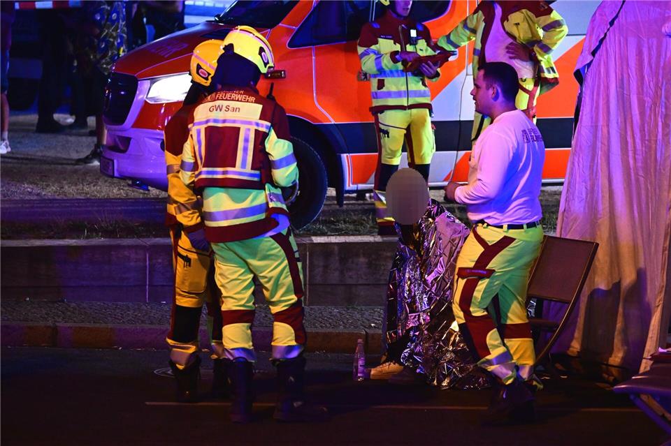 Einsatzkräfte der Feuerwehr versorgen eine Person nach dem Abbruch des Christopher Street Day (CSD).Fabian Sommer/dpa