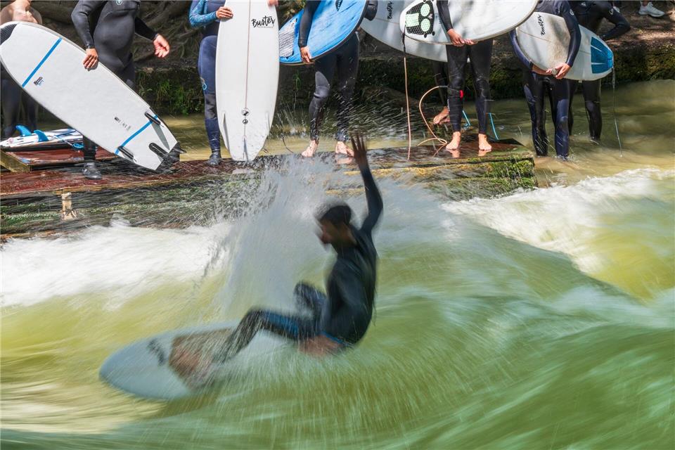 Endlich wieder mit dem Brett auf die Eisbachwelle - darauf hoffen Surferinnen und Surfer in München. (Archivbild)Peter Kneffel/dpa