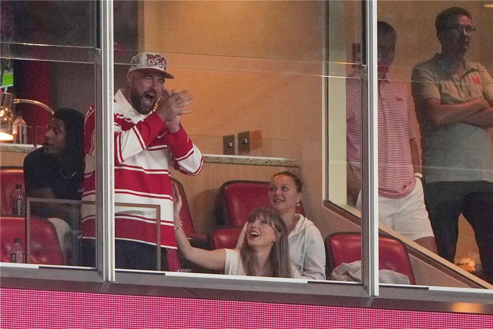 Er jubelt, sie wirft ihm einen verliebten Blick zu: Travis Kelce und Taylor Swift bei einem College-Football-Spiel.Charlie Riedel/AP/dpa