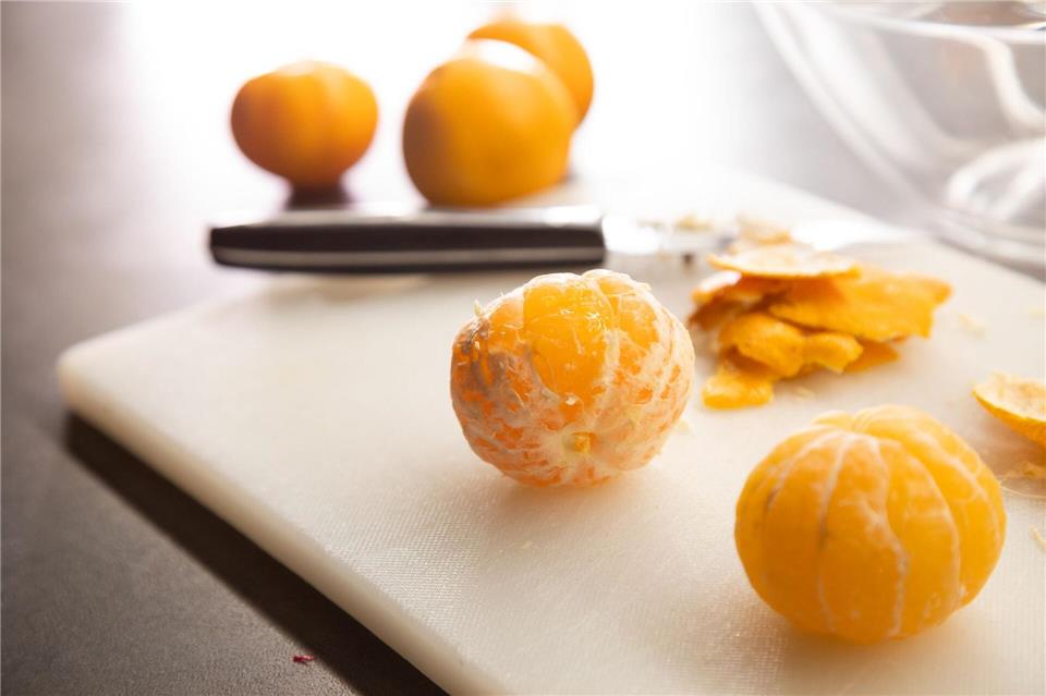 Fazit: Die Clementine aus dem Wasserbad (vorn) ist sauber geschält - es ist kaum weiße Haut übriggeblieben.Christin Klose/dpa-tmn