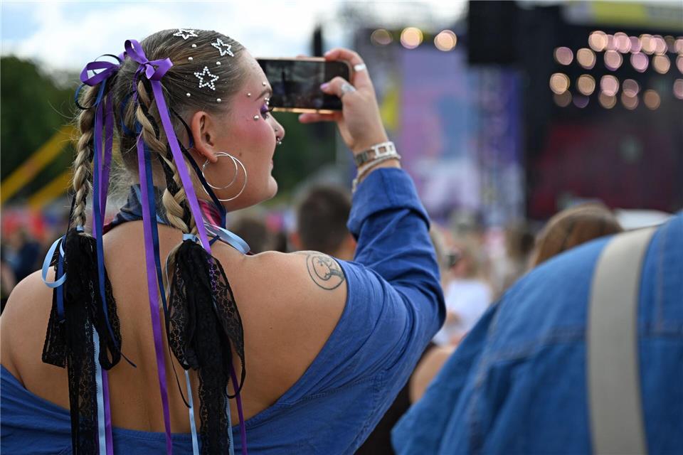 Glitzer, Schminke und bunte Outfits gehören für viele beim Festival dazu.Elisa Schu/dpa