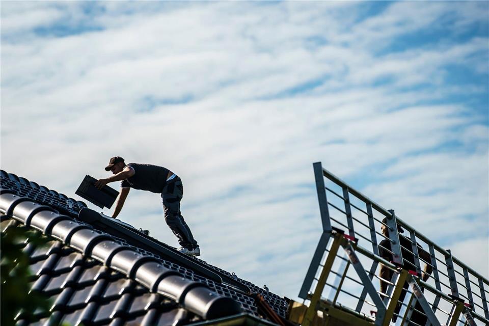 Harter Job auf dem Dach: Montage von Photovoltaik-Anlagen. (Archivbild)Andreas Arnold/dpa