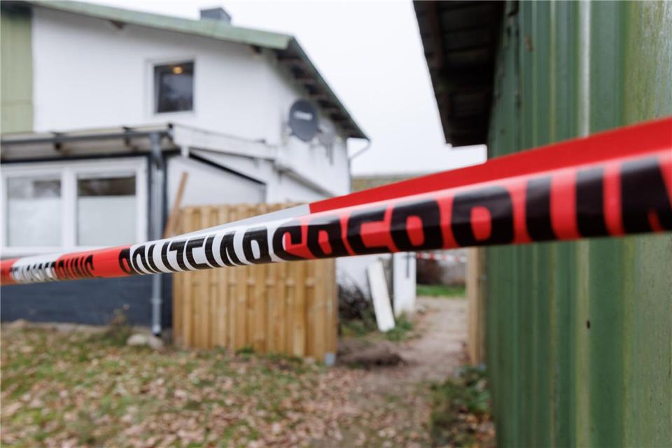 Im Garten ist das Flatterband der Absperrung zu sehen.Markus Scholz/dpa