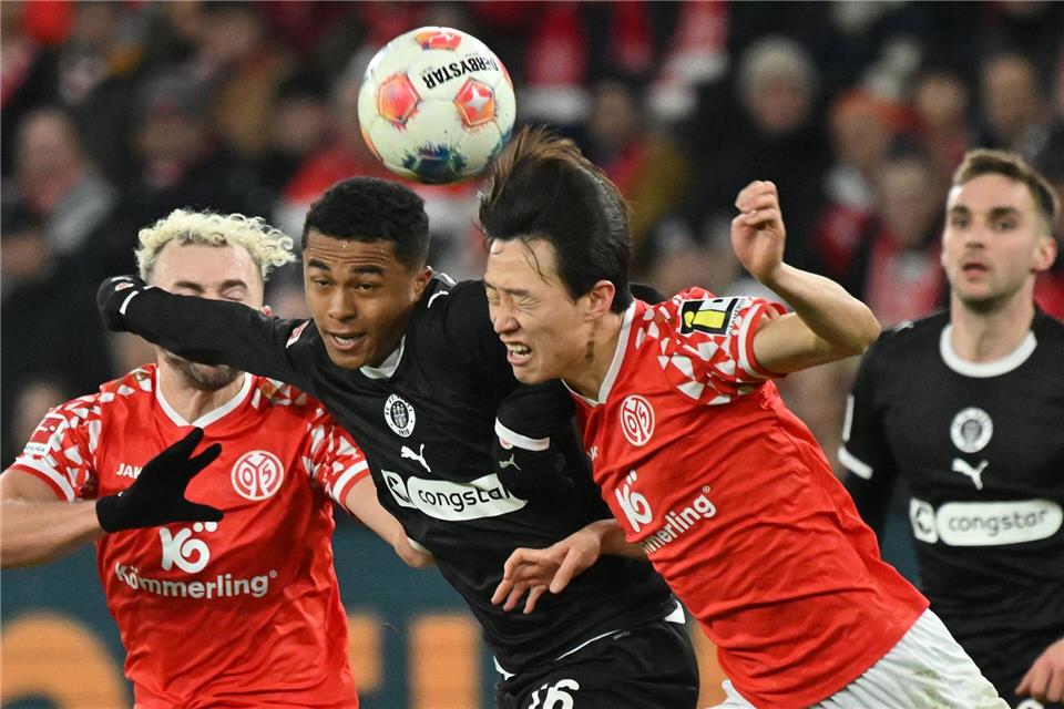 Im Kopfballduell: Joel Chima Fujita vom FC St. Pauli und Jae-sung Lee von Mainz 05.Torsten Silz/dpa