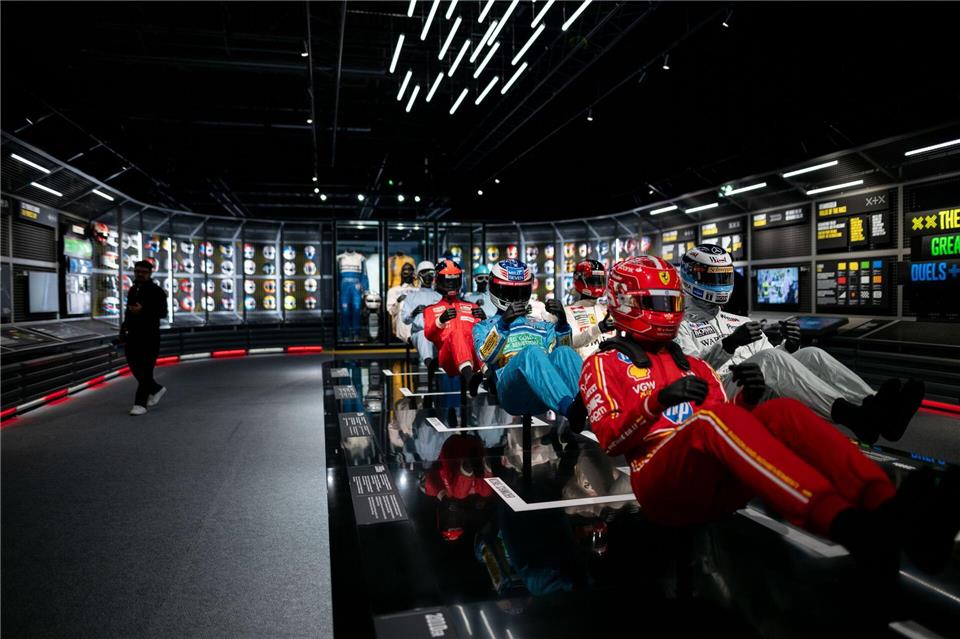 Immer schneller, immer sicherer - Schutzanzüge und Helme bei einer Formel 1-Ausstellung in Oberhausen.Fabian Strauch/dpa