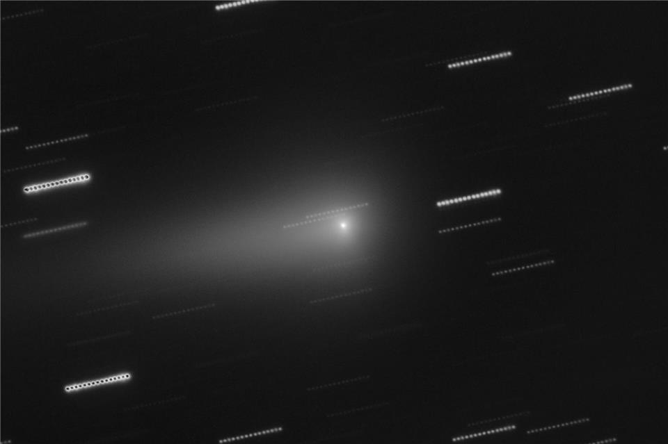 In der Mitte ist der Komet 3I/Atlas zu sehen. Die Sterne im Hintergrund erscheinen als Lichtspuren, weil die Aufnahme aus mehreren nacheinander aufgenommen Einzelbildern zusammengesetzt wurde.O. Hainaut/ESO/dpa