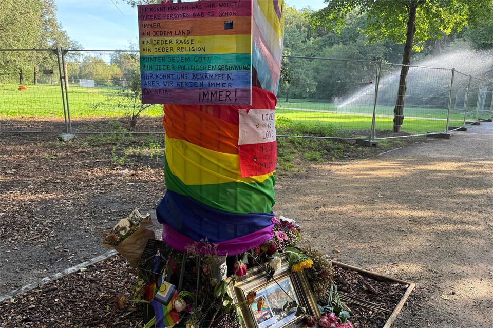 In der Nähe des CSD-Anschlags im Tiergarten liegen Blumen und Fotos in Erinnerung an die Opfer. Marion van der Kraats/dpa
