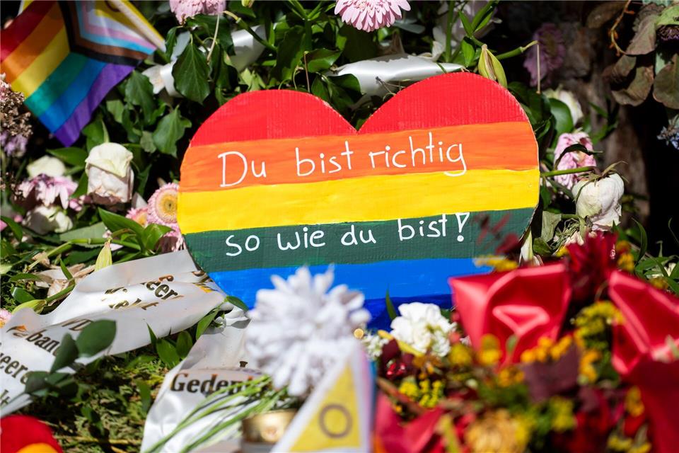 In der Nähe des CSD-Anschlags liegen Blumen, Kerzen und ein Regenbogenfarbenes Herz mit der Aufschrift „Du bist richtig so wie du bist!“. (Archivbild)Christophe Gateau/dpa
