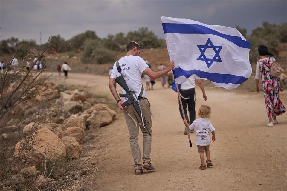 Israelische Siedler gehen auf der Straße zwischen Ganim und Kadim entlang, um die Einweihung des neu errichteten illegalen Außenpostens Kadim im besetzten Westjordanland zu feiern.Ohad Zwigenberg/AP/dpa