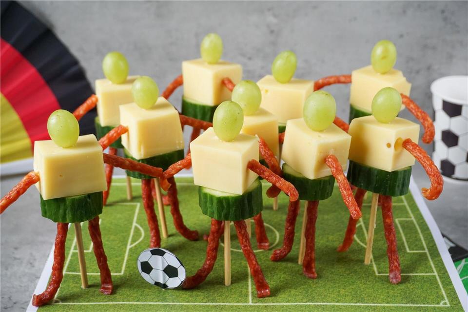 Käse-Trauben-Spieße im Fußballer-Look drängeln sich auf dem Spielfeld von Bloggerin Jenny Böhme. Jenny Böhme/familienkost.de/dpa-tmn