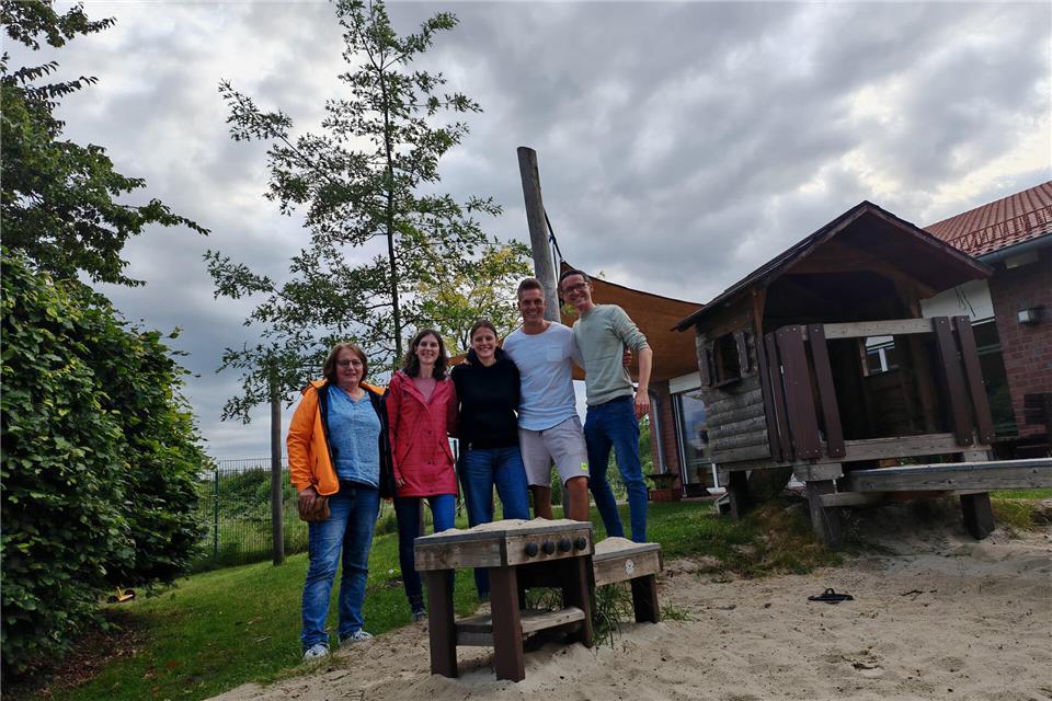 Kitaleiterin Mechthild Westerkamp (l.) freut sich mit dem 2. Vorsitzenden des Fördervereins Tobias Möhlmann (2. v. r.) sowie dem Vorsitzenden Jonathan Schmidt (r.) über den neuen Baum.