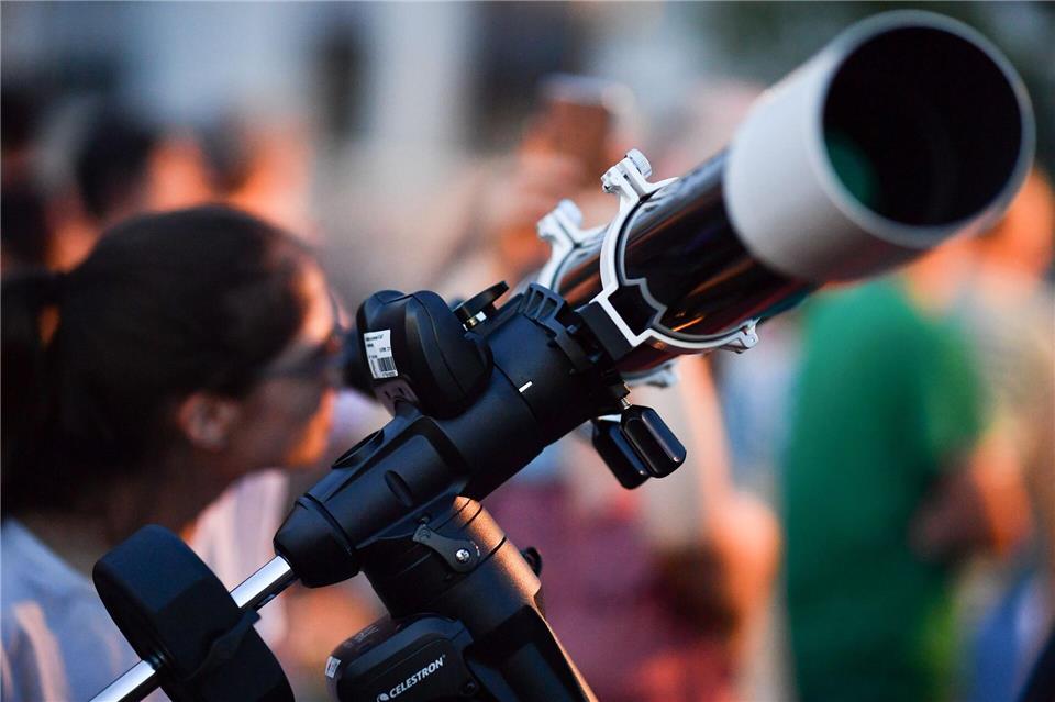 Manche beobachten die Mondfinsternis mit einem Teleskop. (Archivbild)Uwe Anspach/dpa