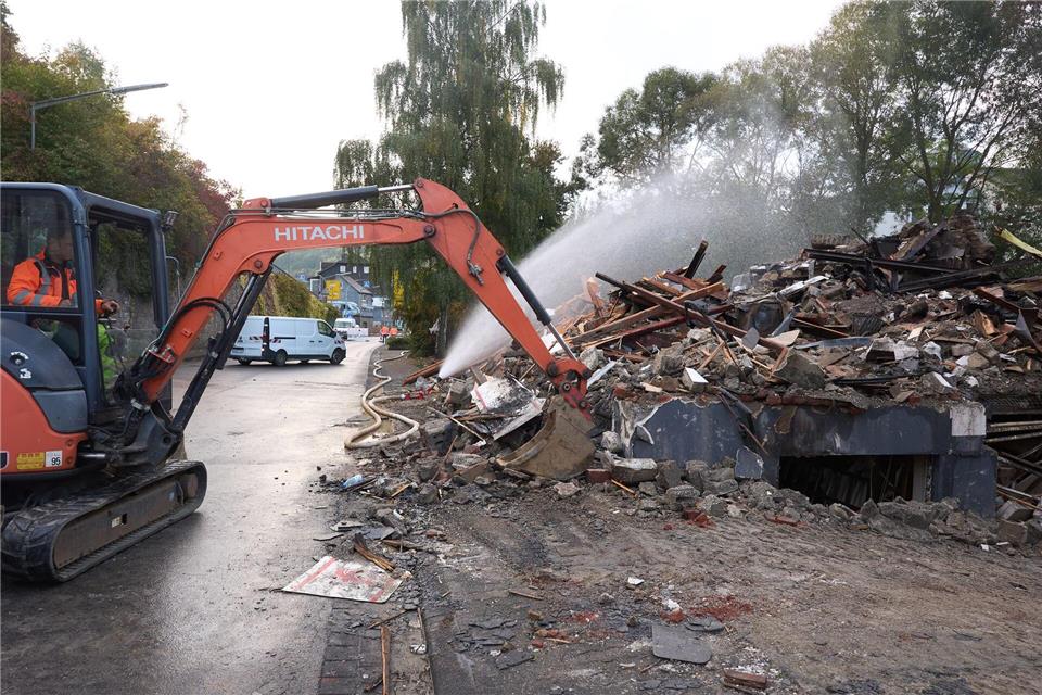 Mit einem Bagger wurden Trümmerteile des Hauses auseinandergezogen. Thomas Frey/dpa