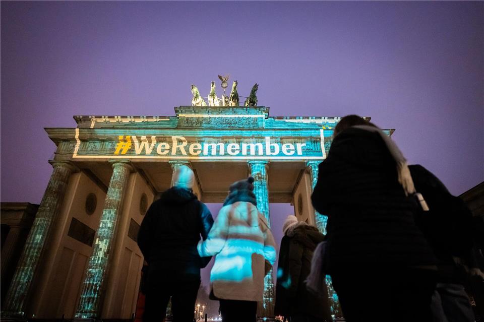 Mit einer Projektion wird an die von Deutschland aus geplanten NS-Verbrechen erinnert.Christoph Soeder/dpa