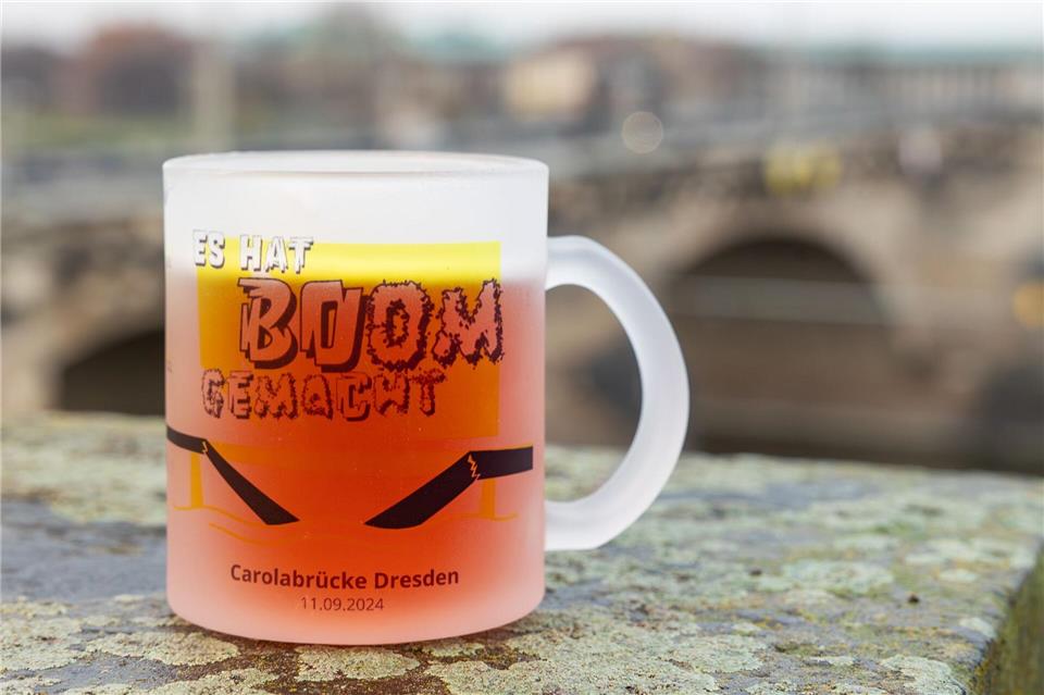 Mit einer neuen Glühweintasse erinnern Dresdner Unternehmer an den Einsturz der Carolabrücke im vergangenen Jahr.Jürgen Lösel/dpa