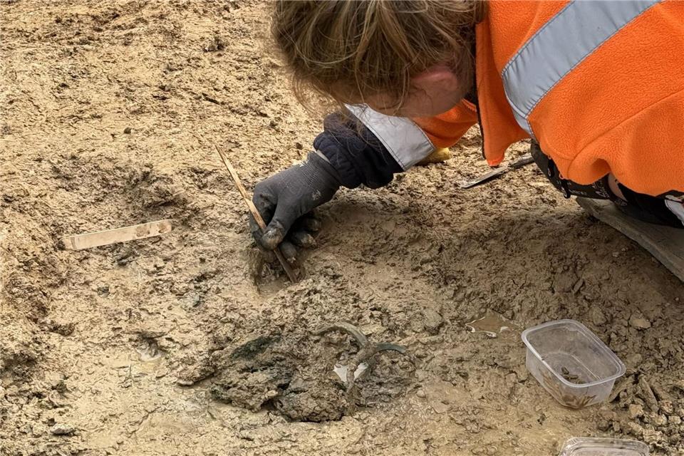 Mit großer Behutsamkeit legen die Archäologen die Grabbeigaben frei - wie hier eine etruskische Kanne, die in dem keltischen Fürstengrab entdeckt wurde. Lars Görze/hessenArchäologie/dpa