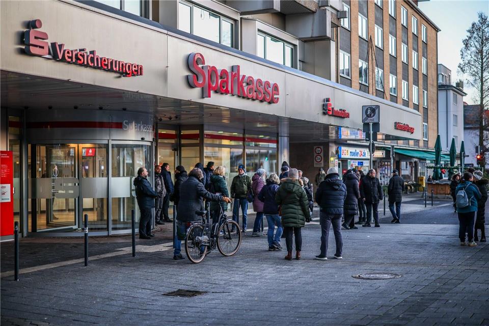 Nach einem Einbruch in den Tresorraum einer Bankfiliale in Gelsenkirchen warten Menschen vor dem Eingang auf Informationen.Christoph Reichwein/dpa
